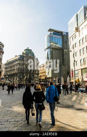 Crowd of people at the Stephansplatz in Vienna, Austria. View of famous landmark with many shops, restaurants, bars and modern buildings Stock Photo