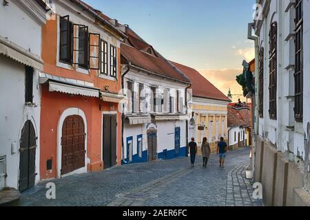 Old street with walking figures in Szentendre, Hungary Stock Photo