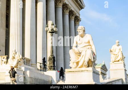 Austrian parliament building with statue on the front Beautiful travel picture with sun light. Stock Photo