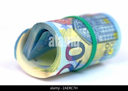 Lots of rolled up banknotes in front of a white background Stock Photo