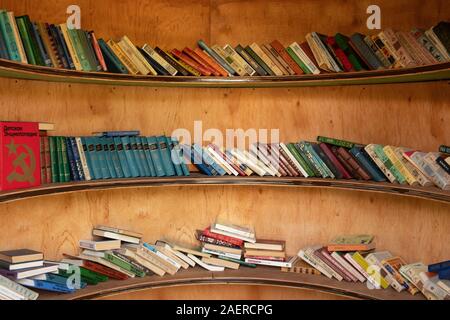 Street library. A large number of books lie on the shelves. Stock Photo