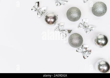 Silver Christmas balls on white background. White copy space for your text. Christmas frame Stock Photo