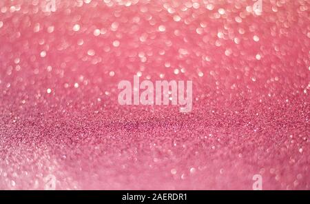 beautiful pink gold sequins on the glitter sparkle of sun light background with blur bright bokeh Stock Photo