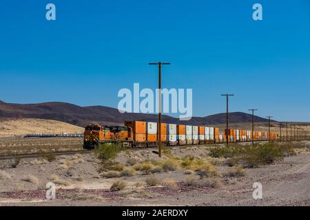 BNSF freight train hauling containers along the line paralleling Route 66 near Ludlow and Amboy in California, USA [No property release; available for Stock Photo