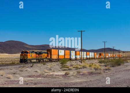 BNSF freight train hauling containers along the line paralleling Route 66 near Ludlow and Amboy in California, USA [No property release; available for Stock Photo