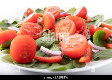 Fresh salad with tomatoes, isolated on white background Stock Photo