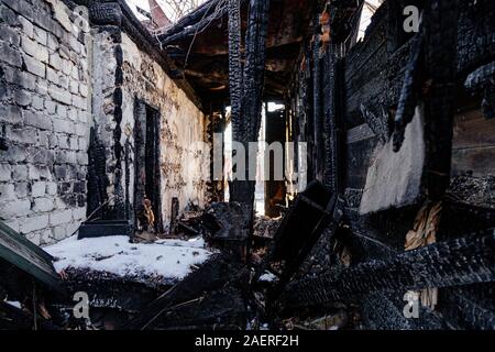 Consequences of fire. Completely burnt old rural house. Stock Photo