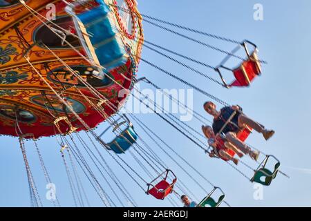 People ride the chain carousel in an amusement park. Cheboksary, Russia, 05/11/2019 Stock Photo