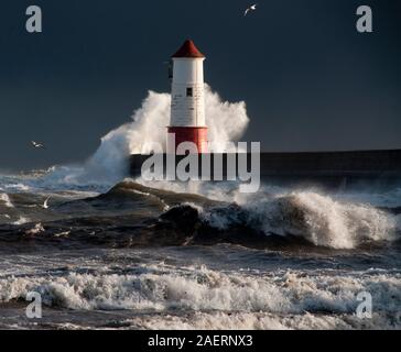 Stormy seas breaking over Berwick Pier (1810-1825) by John Rennie, and lighthouse, (1826) to the designs of Joseph Nelson. Stock Photo