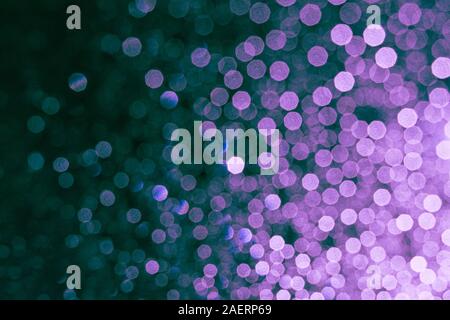 Defocused rain drops on the window shining in the dark Stock Photo