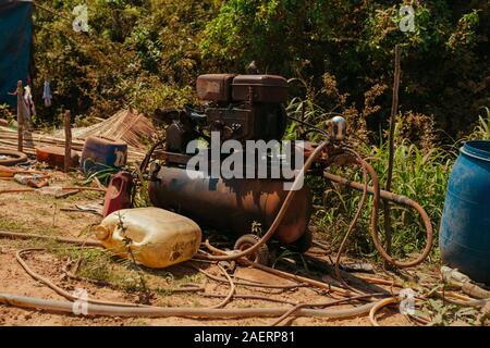 Old rusty air compressor in Cambodian village Stock Photo