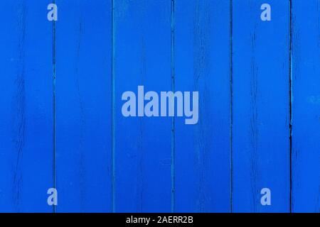 Close-up of an exterior wooden wall. Blue painted wooden planks with knots and vertical cracked. Backgrounds and textures. Copy space for text. Stock Photo
