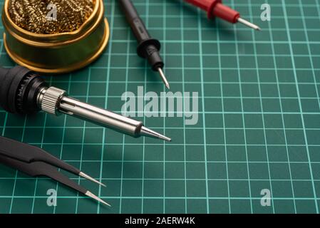 Electronics Development Concept. Hobbies are electronics. Soldering iron and tools on the desktop. Stock Photo