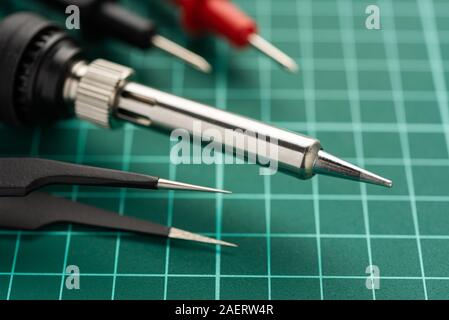 Electronics Development Concept. Hobbies are electronics. Soldering iron and tools on the desktop. Stock Photo