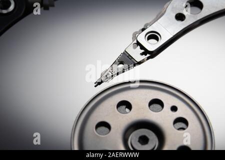 Open hard disk drive. The concept of data storage. Data array. Magnetic head on the surface of the disk.. Stock Photo