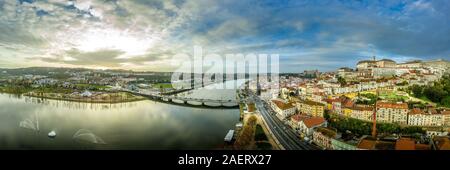 View of the Ponte Rainha Santa Isabel in Coimbra over the Mondego river with the sun setting in the back Stock Photo