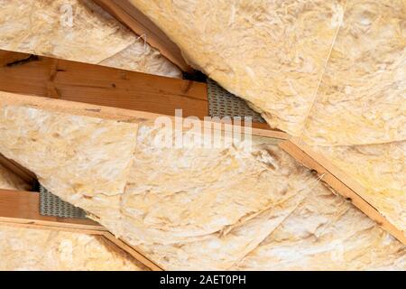 Glass mineral wool insulation in between roof rafters. Stock Photo