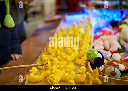 Rubber ducks floating to be caught with a fishing rod at a fairground