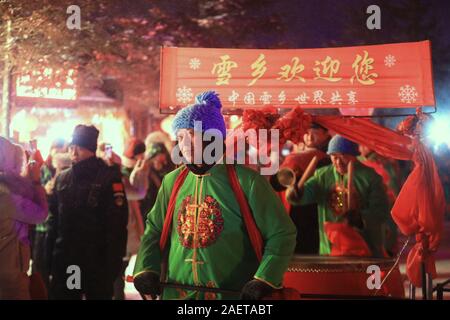 Peope dance at the Snow Carnival at the China Snow Town in Mudanjiang city, north-east China's Heilongjiang province, 27 November 2019.   To attract m Stock Photo