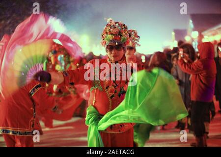 Peope dance at the Snow Carnival at the China Snow Town in Mudanjiang city, north-east China's Heilongjiang province, 27 November 2019.   To attract m Stock Photo