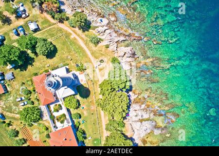 Savudrija lighthouse and turquoise crystal clear rocky beach aerial view, westernmost point of Croatia Stock Photo