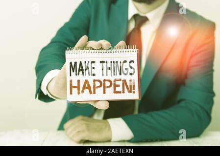 Conceptual hand writing showing Make Things Happen. Concept meaning you will have to make hard efforts in order to achieve it Man holds empty paper wi Stock Photo