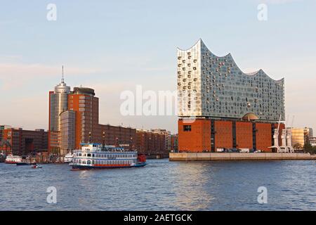 Paddle wheel steamer Louisiana European Starling in Hamburg harbour in front of the Hanseatic Trade Center and Elbe Philharmonic Hall at the