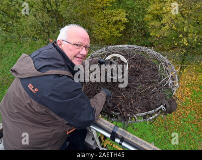 Karlsruhe, Germany. 18th Nov, 2019. Stefan Eisenbarth cleans a stork's nest on a voluntary basis. Plastic waste in particular, which storks bring into the nest as supposed food or nesting material, is harmful for the animals. (to dpa: 'Cleaning in the stork's nest - danger by plastic garbage') Credit: Uli Deck/dpa/Alamy Live News Stock Photo