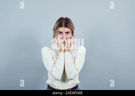 Beautiful woman suffering pain on hands arthritis inflammation, looking scary Stock Photo