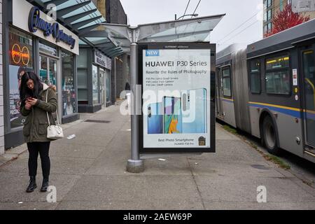 Vancouver, BC, Canada - Oct 12, 2019: Huawei advertisement is seen at a bus stop on West Broadway in Vancouver. Stock Photo