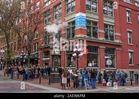 Crowds of tourists admire the Gastown Steam Clock as it chimes with the Big Ben chimes in Vancouver, BC, Canada, on Sunday, Oct 13, 2019. Stock Photo