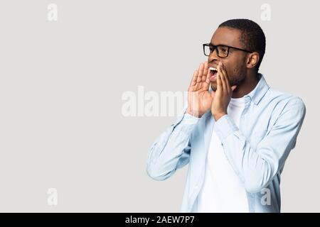 Emotional african american millennial guy shouting at copyspace. Stock Photo