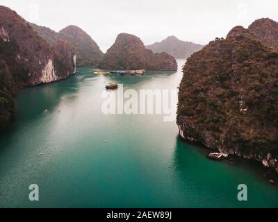 Stunning Halong Bay in Vietnam. Halong cruise in foggy weather through the world famous Bay. Amazing views cruise ship. Stock Photo