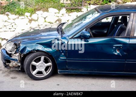 Damaged left wing of a car after a road traffic accident, Crete, Greece Stock Photo