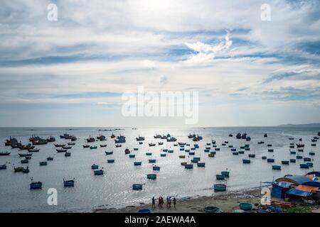 Traditional Vietnamese boat in the basket shaped on fishing port at Fishing village in sunset sky, Binh Thuan, Vietnam. Landscape. Popular landmark, f Stock Photo