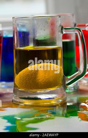 Glasses with paint for Easter eggs. Easter Egg decorating. Close up, soft focus Stock Photo