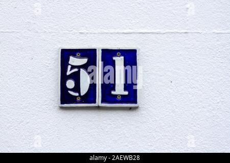 House number 51 in white on blue tiles Stock Photo