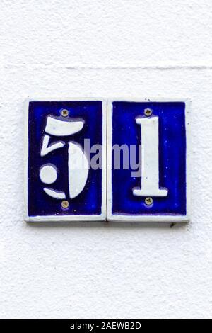 House number 51 in white on blue tiles Stock Photo