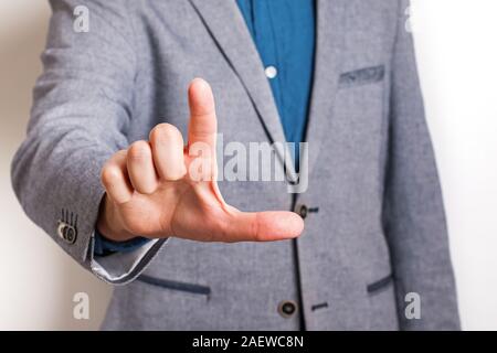 Man wearing suit pointing with his forefinger close-up. Stock Photo