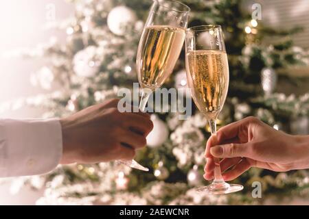Celebration christmas and new year. Couple holding glasses of sparkling wine Stock Photo