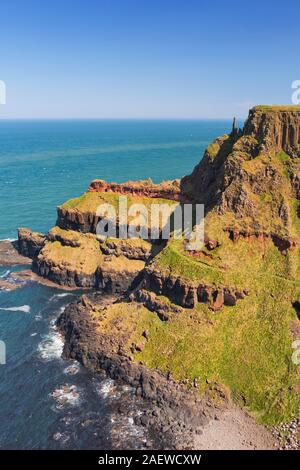Cliffs with the Chimney Stacks rock formation on the Causeway Coast in Northern Ireland on a bright and sunny day. Stock Photo