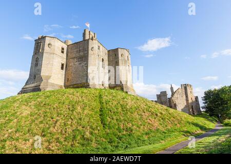 The view from outside the property of Warkworth Castle, a ruined medieval building in the village of Warkworth in Northumberland, England. Stock Photo