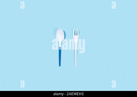 So beautiful and so dangerous plastic spoons. Environmental problem of plastic rubbish pollution. Central composition. Stock Photo