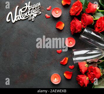 Valentines day romantic background - red roses, glasses, candle and hearts. Flat lay, copy space. Stock Photo