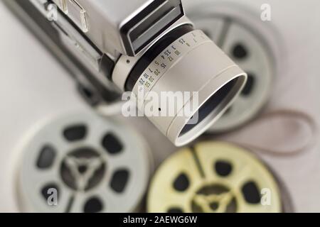 Old 8mm camera  with film reels blurred in a background Stock Photo