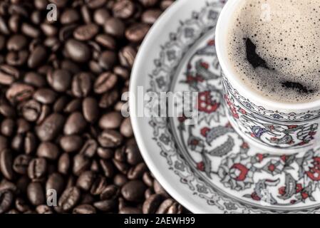 Turkish cup of coffee foam roasted beans background Stock Photo