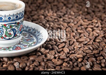 Turkish cup of coffee foam roasted beans background Stock Photo