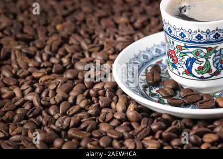 Turkish cup of coffee foam roasted beans background Stock Photo