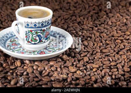 Turkish cup of coffee foam roasted beans background Stock Photo