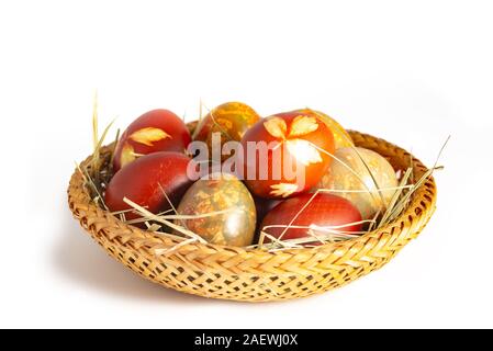 Traditional easter painted eggs in straw basket Stock Photo